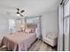 Bedroom with a ceiling fan, hardwood floors, a reading chair, and an ensuite bathroom at 5231 32Nd E St, Bradenton, FL 34203
