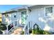 Charming home featuring a covered front porch, a stylish teal door, and well-maintained landscaping at 5231 32Nd E St, Bradenton, FL 34203