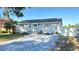 Landscaped home featuring a gray brick driveway, a well-maintained yard, and a light-blue exterior at 5231 32Nd E St, Bradenton, FL 34203