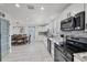 Open concept kitchen with stainless steel appliances, tile floors, and dining area with modern pendant lighting at 5231 32Nd E St, Bradenton, FL 34203