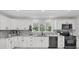 Modern kitchen featuring white cabinets, sleek appliances, and a stylish backsplash at 5231 32Nd E St, Bradenton, FL 34203