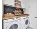 Well-organized laundry room with modern machines, wood countertop, and overhead cabinets at 5231 32Nd E St, Bradenton, FL 34203