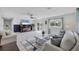 Spacious living room with tile floors, a ceiling fan, and access to the outdoor deck at 5231 32Nd E St, Bradenton, FL 34203