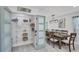 Walk-in pantry with shelving, next to a dining area with a wooden table and seating for six at 5231 32Nd E St, Bradenton, FL 34203
