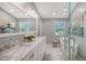 Elegant bathroom featuring a soaking tub, marble countertop, and contemporary decor at 5324 Siesta Ct, Sarasota, FL 34242