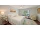 Charming bedroom with a queen-size bed, a window view, and a decorative rug at 5324 Siesta Ct, Sarasota, FL 34242