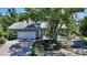 Lovely single-story home with a two-car garage, lush landscaping, and mature trees at 5324 Siesta Ct, Sarasota, FL 34242