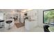 Bright modern kitchen featuring white cabinetry, stainless steel appliances, and a stylish breakfast bar at 5324 Siesta Ct, Sarasota, FL 34242