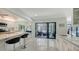 Open concept kitchen with bar seating and sliding glass doors to a patio at 5324 Siesta Ct, Sarasota, FL 34242