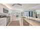 Stylish modern kitchen with stainless appliances, bright countertops, and a breakfast bar at 5324 Siesta Ct, Sarasota, FL 34242