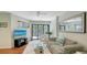 Relaxing living room boasting a plush sofa, a cozy rug, and seamless access to the outdoor balcony at 5324 Siesta Ct, Sarasota, FL 34242