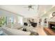 Spacious open-concept living area featuring a brick fireplace and tile flooring at 5324 Siesta Ct, Sarasota, FL 34242