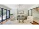 Charming living room featuring a large mirror reflecting the nearby kitchen and access to the outdoor deck at 5324 Siesta Ct, Sarasota, FL 34242