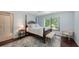 Bright main bedroom showcasing hardwood floors, ample natural light, and a comfortable seating area at 5324 Siesta Ct, Sarasota, FL 34242