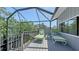 Relaxing screened patio featuring lounge chairs and a view of the trees at 5324 Siesta Ct, Sarasota, FL 34242
