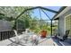 Enclosed patio showcasing a dining set overlooking a lush outdoor view at 5324 Siesta Ct, Sarasota, FL 34242