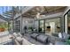 A covered patio has wicker furniture, fan, spiral staircase and an open doorway to the home at 5324 Siesta Ct, Sarasota, FL 34242