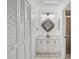 Bathroom featuring a vanity with white cabinets and a mirror with decorative sunburst frame at 5354 Myrtle Wood # 50, Sarasota, FL 34235