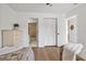 Cozy bedroom with wood floors, white walls, and en-suite bathroom access at 5354 Myrtle Wood # 50, Sarasota, FL 34235