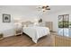 Bright bedroom with a queen bed, hardwood floors, a ceiling fan, and natural light at 5354 Myrtle Wood # 50, Sarasota, FL 34235