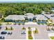 An aerial shot of the community clubhouse featuring a lovely parking area and stunning landscaping at 5354 Myrtle Wood # 50, Sarasota, FL 34235