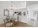 Dining area with view to the kitchen, featuring modern lighting and tile floors at 5354 Myrtle Wood # 50, Sarasota, FL 34235