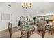 Charming dining room featuring a glass table, decorative chairs, and views of the living area at 5354 Myrtle Wood # 50, Sarasota, FL 34235