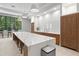 A brightly lit kitchen with a long center island, pendant lighting, and stainless steel appliances at 5354 Myrtle Wood # 50, Sarasota, FL 34235