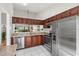 Well-lit kitchen with stainless steel appliances and granite countertops offering a clean aesthetic at 5354 Myrtle Wood # 50, Sarasota, FL 34235