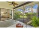 Relaxing screened lanai with stylish chair and view of the lush backyard at 5354 Myrtle Wood # 50, Sarasota, FL 34235