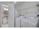 Bright laundry room with shelving, washer, and dryer; next to the bathroom at 5354 Myrtle Wood # 50, Sarasota, FL 34235