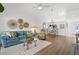 Bright living area featuring wood floors, vaulted ceiling, and view to the kitchen at 5354 Myrtle Wood # 50, Sarasota, FL 34235