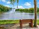 Bench and pond featuring a beautiful fountain in a serene park, ideal for peaceful contemplation at 5354 Myrtle Wood # 50, Sarasota, FL 34235