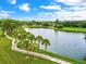 Path and pond with palm trees in a picturesque setting, inviting for peaceful walks at 5354 Myrtle Wood # 50, Sarasota, FL 34235