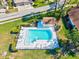 Aerial view of a sparkling pool with plenty of space for lounge chairs and a small pool house, perfect for relaxation at 5354 Myrtle Wood # 50, Sarasota, FL 34235