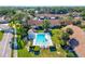 Aerial view of a swimming pool with lounge chairs and a small pool house, in the middle of residential housing at 5354 Myrtle Wood # 50, Sarasota, FL 34235