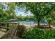 Lush landscaping surrounds the gorgeous tennis court, complete with lighting and shade at 5354 Myrtle Wood # 50, Sarasota, FL 34235