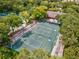An aerial view of tennis courts, surrounded by lush trees and greenery, ideal for recreation at 5354 Myrtle Wood # 50, Sarasota, FL 34235