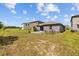 Spacious backyard featuring a patio with outdoor seating and a well-maintained lawn at 5554 Blue Azure Dr, Wimauma, FL 33598