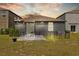 Cozy backyard with a small patio and string lights, perfect for outdoor entertaining at 5554 Blue Azure Dr, Wimauma, FL 33598