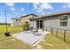 View of the backyard featuring a small patio area with outdoor seating and string lights overhead at 5554 Blue Azure Dr, Wimauma, FL 33598