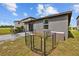 View of the backyard featuring a small patio area and a fenced area for pets or other uses at 5554 Blue Azure Dr, Wimauma, FL 33598