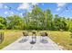 Landscaped backyard featuring a cozy patio area with stylish seating and decorative lighting at 5554 Blue Azure Dr, Wimauma, FL 33598