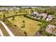 Aerial view of a fully-fenced and well-kept community dog park at 5554 Blue Azure Dr, Wimauma, FL 33598