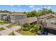 Charming two-story home with well-manicured lawn, lush landscaping, and a blue car in the driveway at 5554 Blue Azure Dr, Wimauma, FL 33598