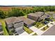Aerial view of a residential street, featuring well-maintained homes, driveways, and landscaping at 5554 Blue Azure Dr, Wimauma, FL 33598