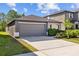 Charming one-story home with a two-car garage and well-maintained landscaping at 5554 Blue Azure Dr, Wimauma, FL 33598