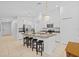 Bright, white kitchen featuring a center island with granite countertops and modern pendant lighting at 5554 Blue Azure Dr, Wimauma, FL 33598