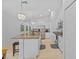 Well-lit kitchen includes an island with seating, stainless steel appliances, and tile floors at 5554 Blue Azure Dr, Wimauma, FL 33598