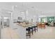 Open concept kitchen featuring an island with bar seating, granite countertops, and stainless steel appliances at 5554 Blue Azure Dr, Wimauma, FL 33598